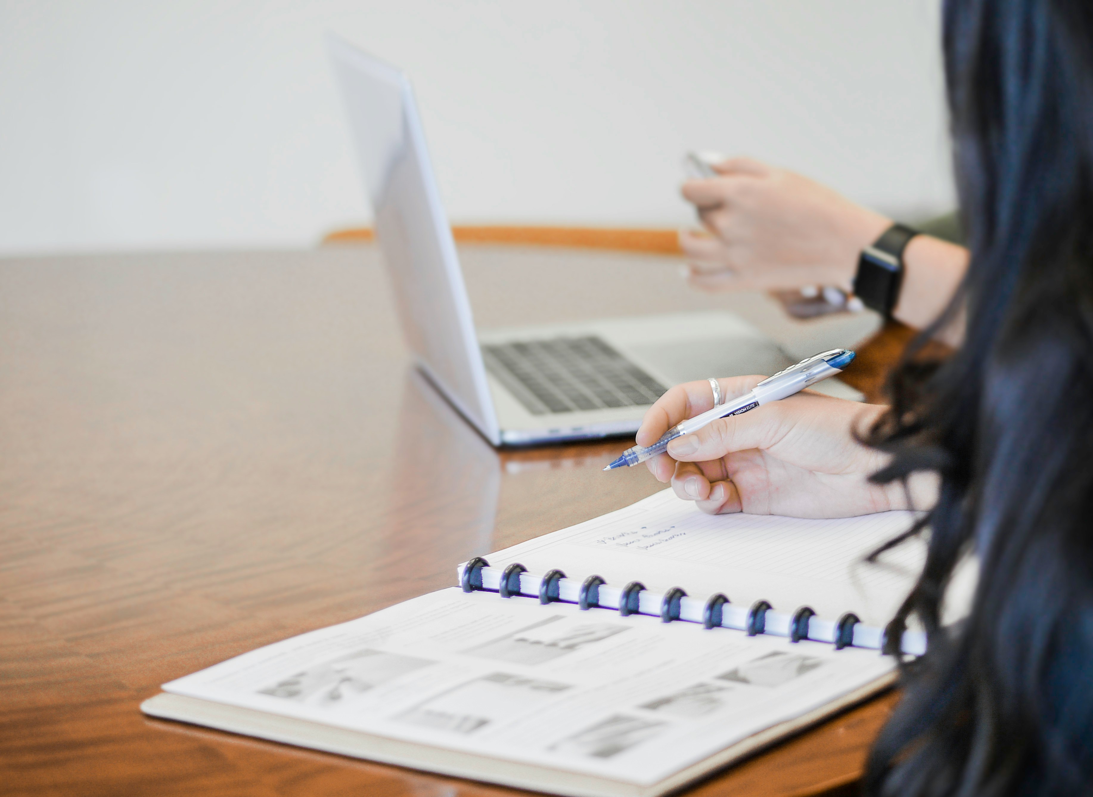 Homeowner taking notes and researching remodeling ideas on a laptop before an in-home kitchen or bathroom consultation in Surprise, AZ