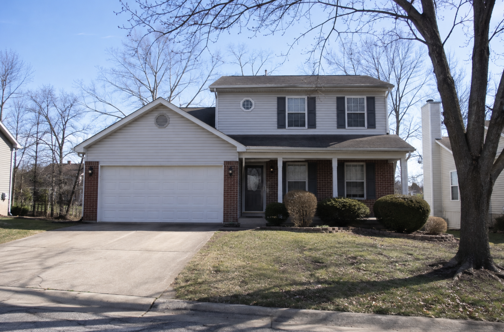 A two-story suburban St. Louis area home with a brick and vinyl exterior