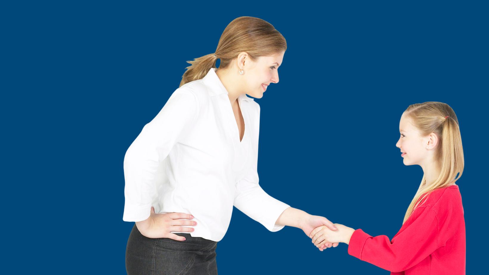 An adult and child shaking hands.