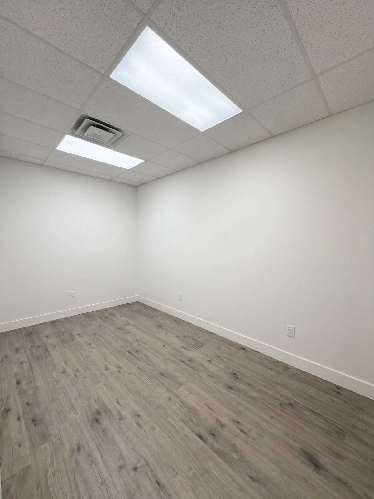 Bright remodeled office suite interior with new flooring at The Rigby Office Hub