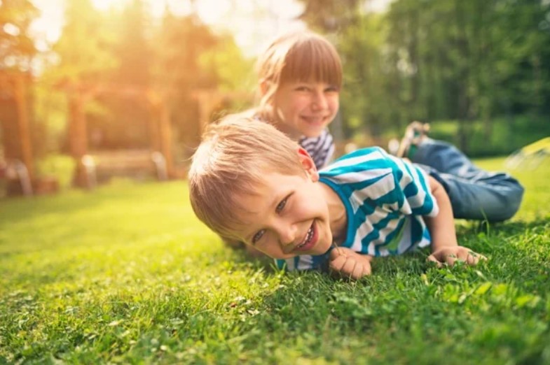 Child with pet dog in backyard