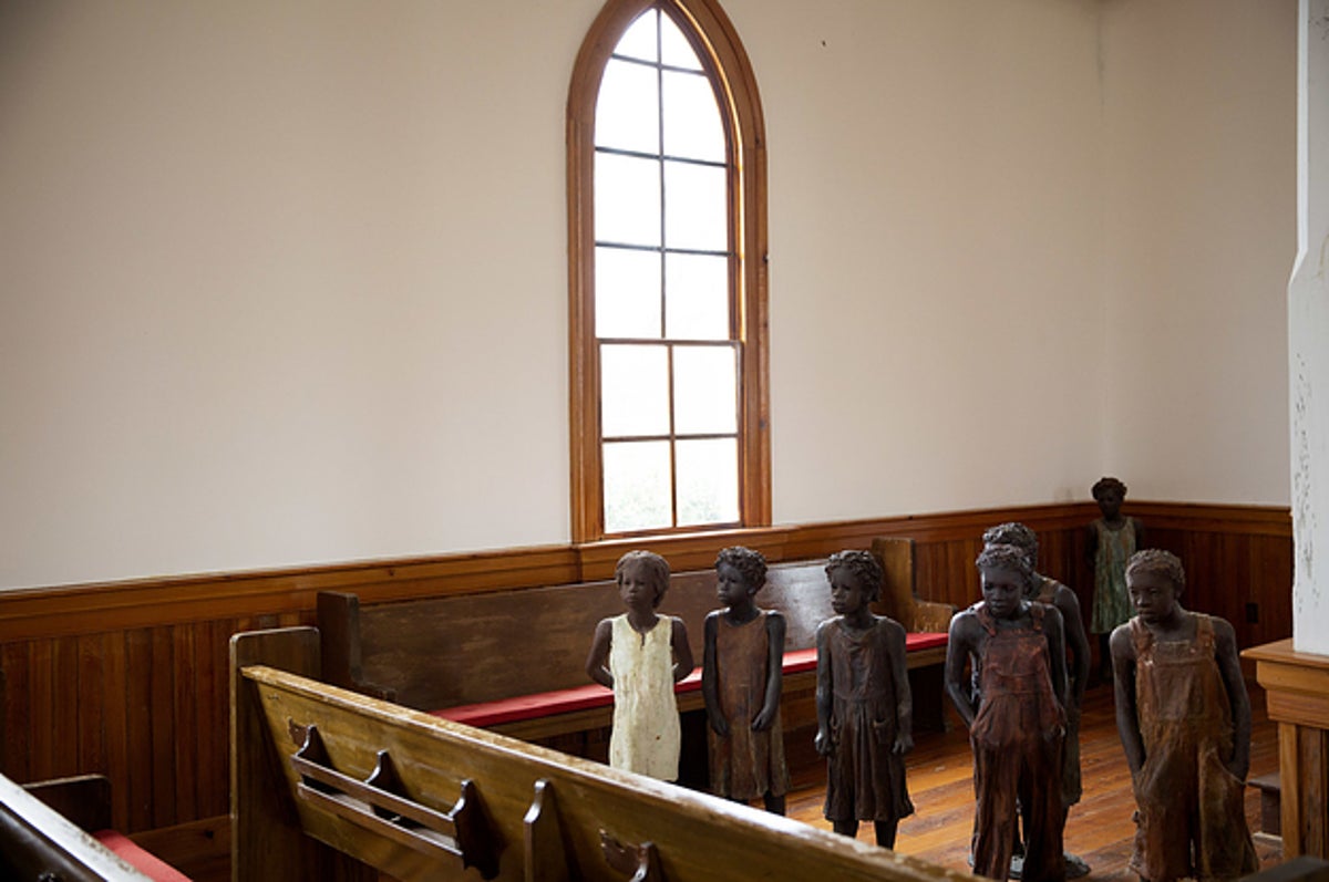 Sculpted children statues standing in sanctuary of historic plantation chapel