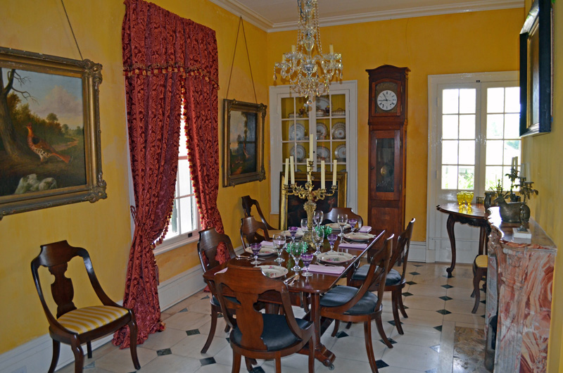 Elegant antebellum dining room with crystal chandelier and antique furnishings