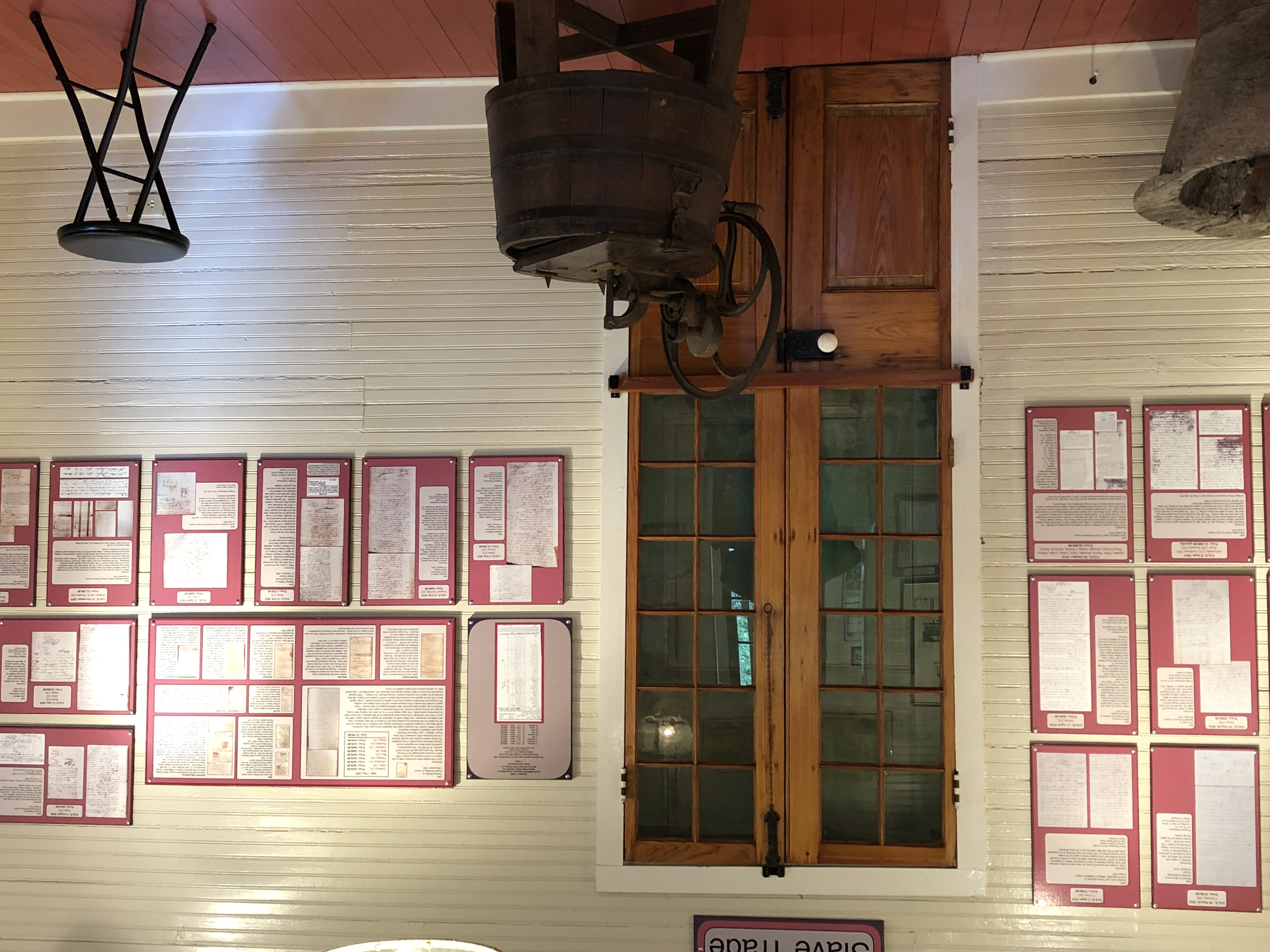 Slave Trade exhibition room with historic wooden churn press and archives