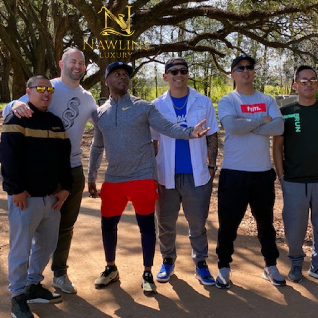 Guests posing beneath the oak canopy at a plantation stop