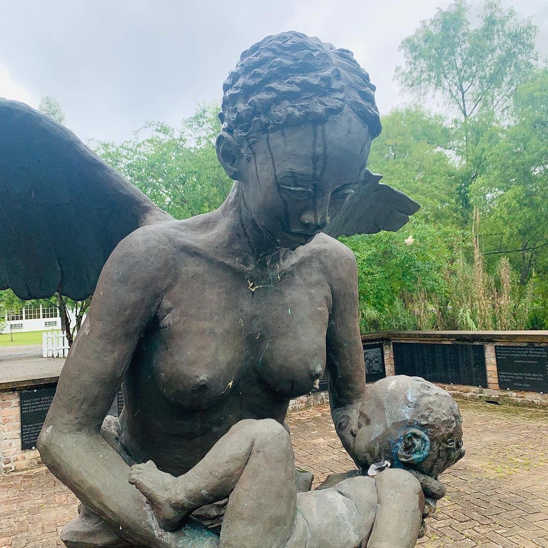 Angel sculpture cradling an infant at the Field of Angels memorial