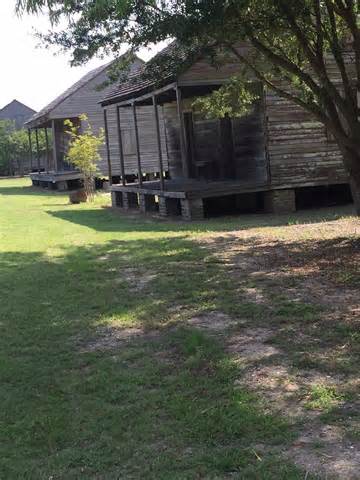 Row of historic wooden slave quarters cabins on plantation grounds