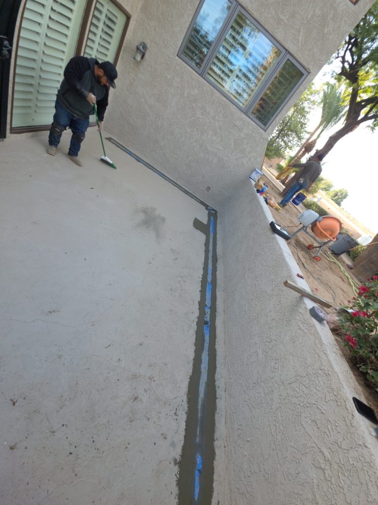 Progress: Landscaping crew installing a custom concrete patio