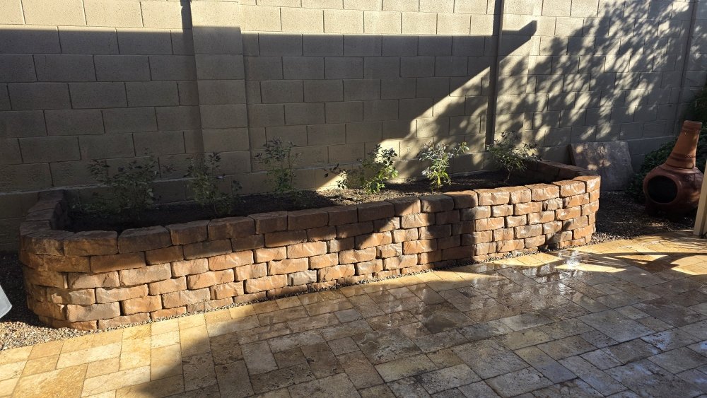 Custom raised stone planter box and paver patio installation