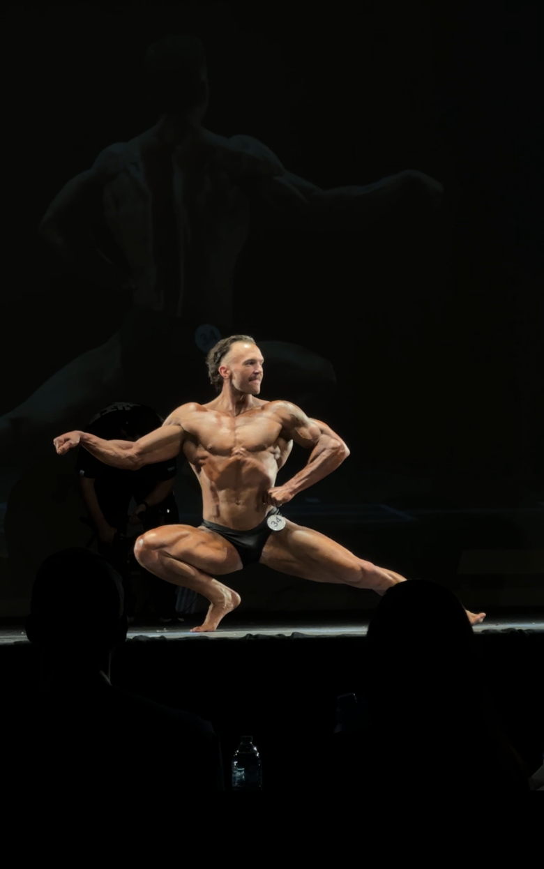 Bodybuilder posing on stage mobile background