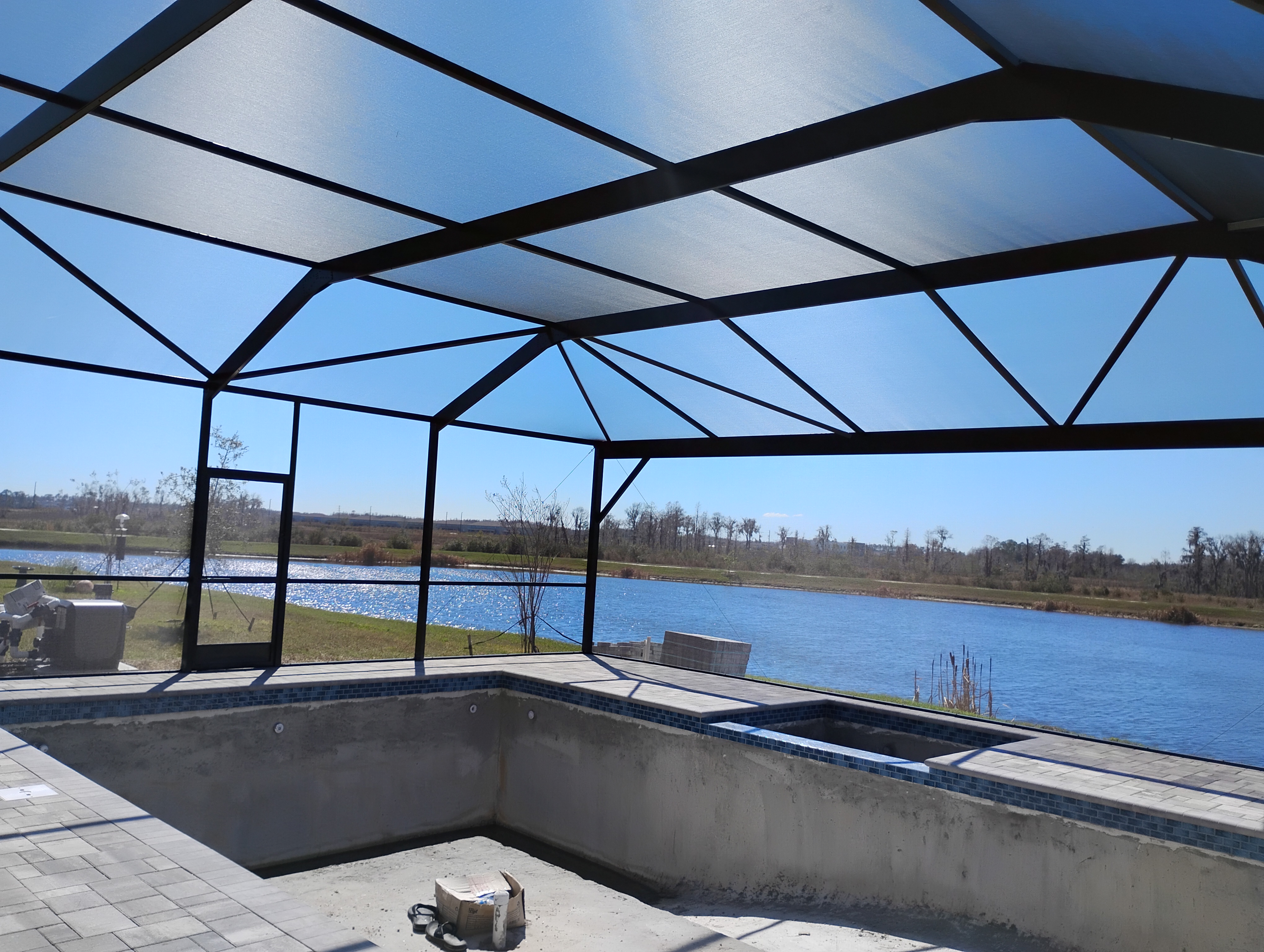 Riverview custom pool enclosure installation overlooking lake