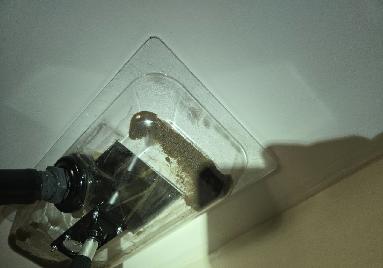 JLX Environmental air duct cleaning extraction vacuum hood collecting particulate at ceiling register
