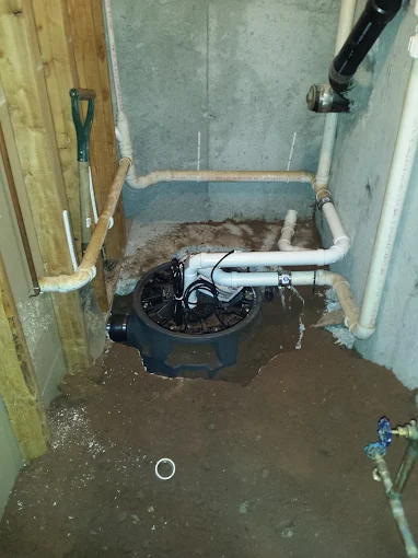 Basement sewage ejector pit basin and submersible pump installation with PVC discharge line and vent piping in dirt subfloor Dunwoody GA Basement sewage ejector pit basin and submersible pump installation with PVC discharge line and vent piping in dirt subfloor Dunwoody GA