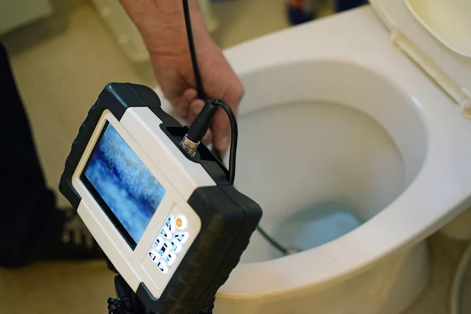 Lofton's DNA Plumbing technician using digital monitor camera snake down toilet drain for sewer diagnostic inspection Smyrna GA Lofton's DNA Plumbing technician using digital monitor camera snake down toilet drain for sewer diagnostic inspection Smyrna GA