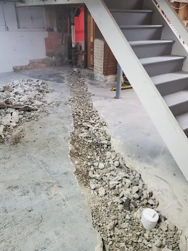 Basement trench gravel backfilling and subfloor PVC cleanout access plug installation underneath basement stairs Decatur GA Basement trench gravel backfilling and subfloor PVC cleanout access plug installation underneath basement stairs Decatur GA