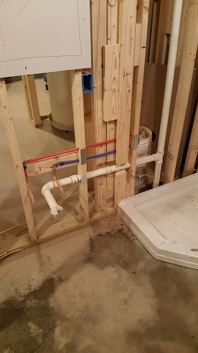 Professional rough-in plumbing installation featuring PEX hot and cold water lines and PVC drain lines in wooden wall studs Buckhead Atlanta GA Professional rough-in plumbing installation featuring PEX hot and cold water lines and PVC drain lines in wooden wall studs Buckhead Atlanta GA