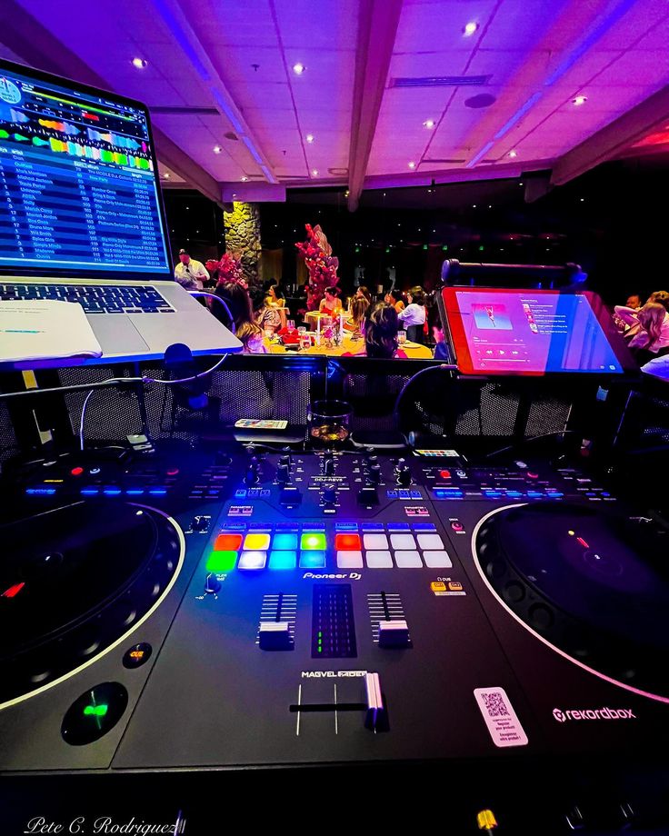 Live event DJ booth perspective overlooking dance floor