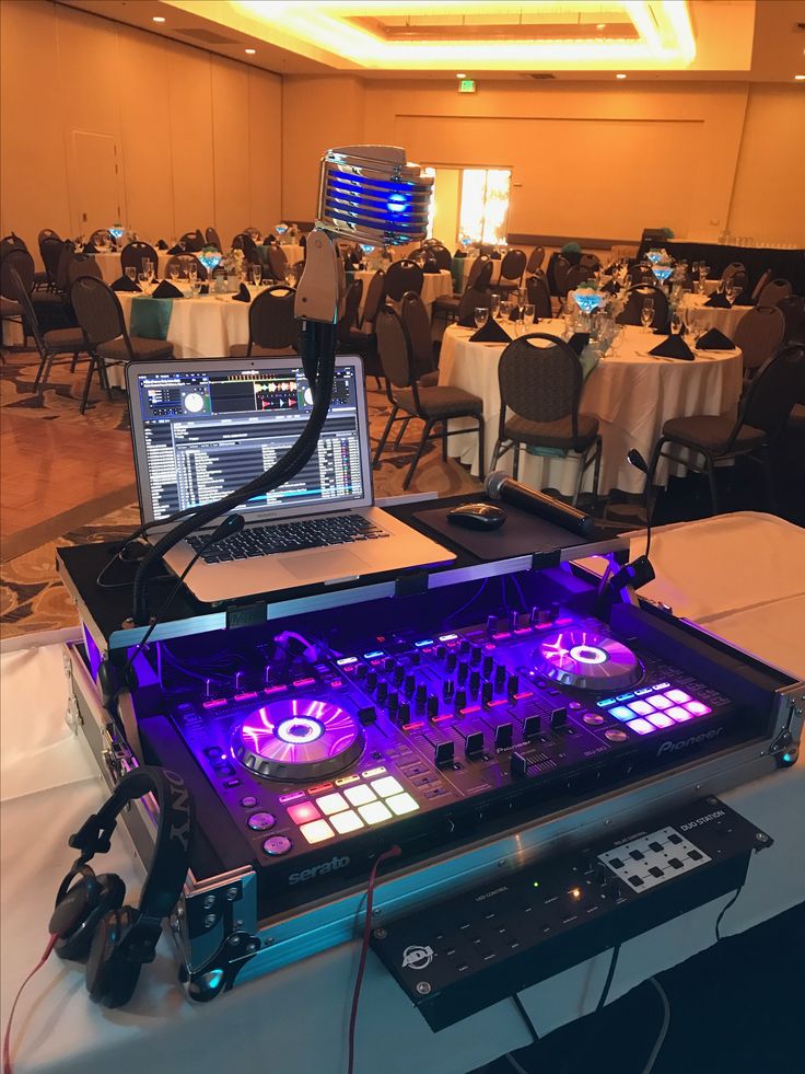 Illuminated DJ controller with Serato laptop and vintage microphone