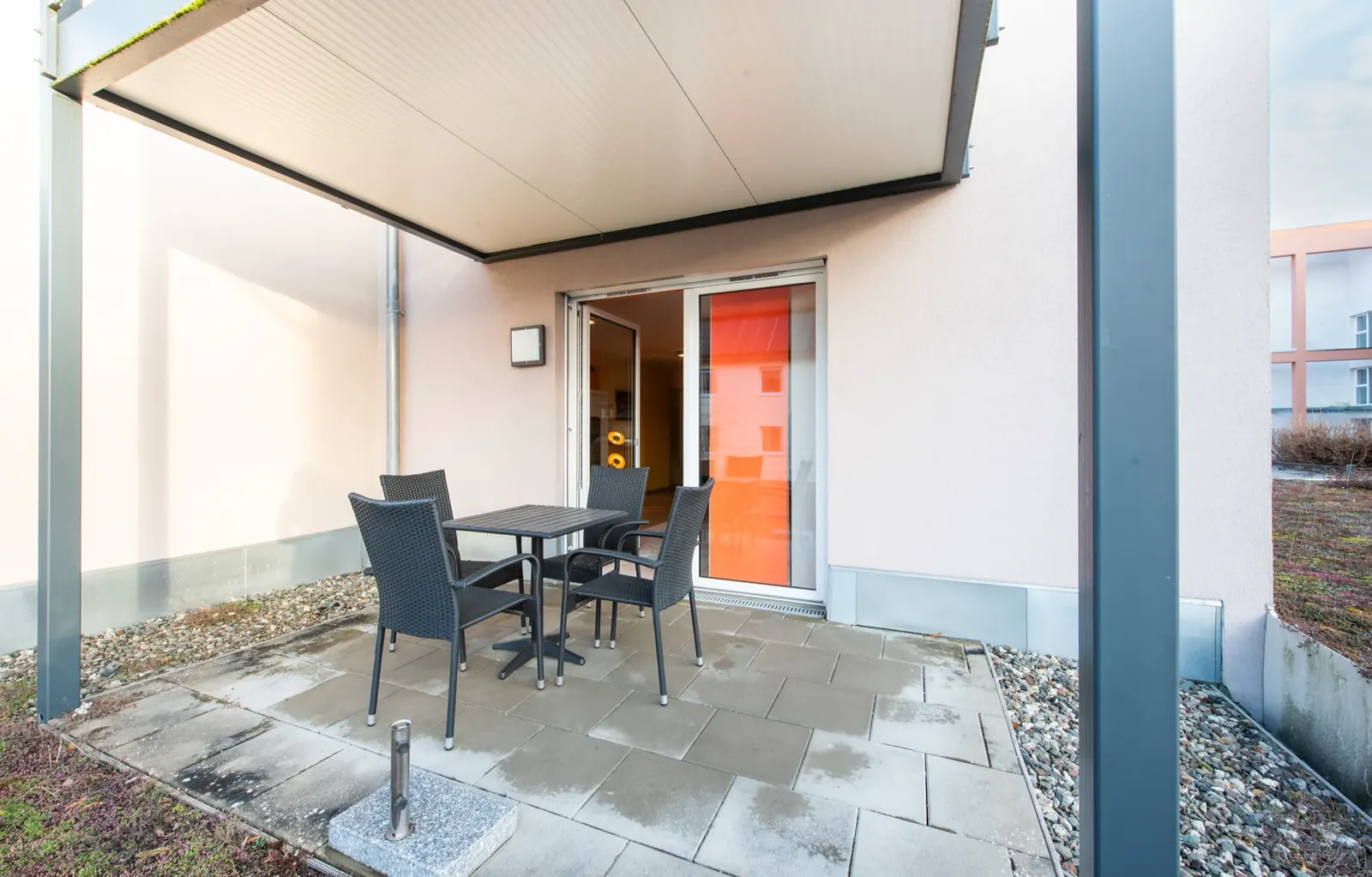 Access & Surroundings – Covered terrace with seating area