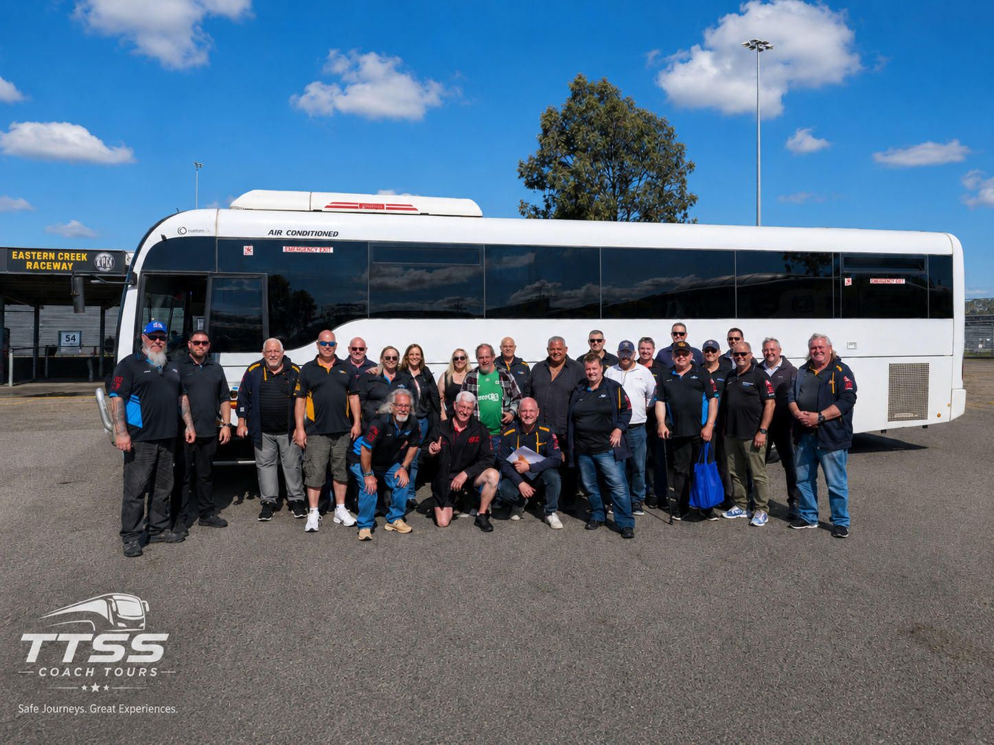 TTSS Coach Tours luxury air-conditioned charter bus with tour group at Eastern Creek Raceway Sydney