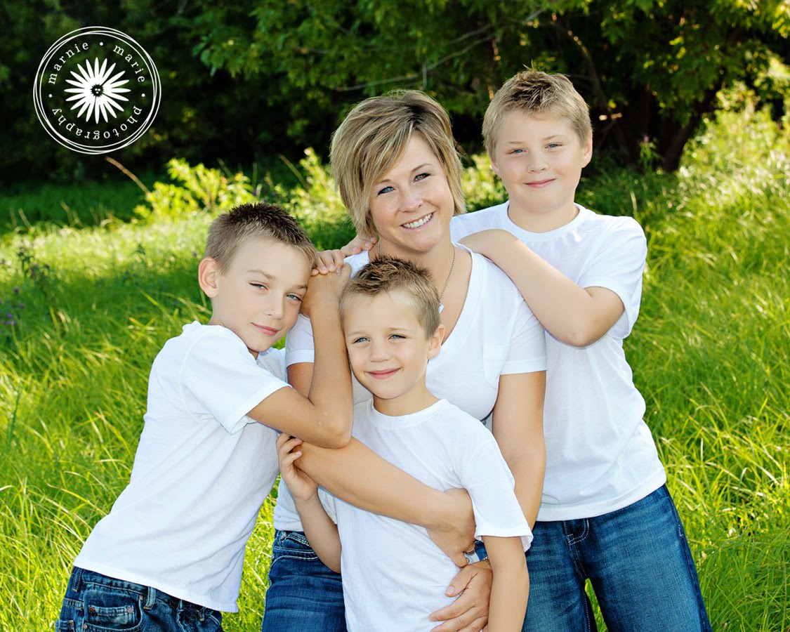 Lori with her three young boys outdoors in a field