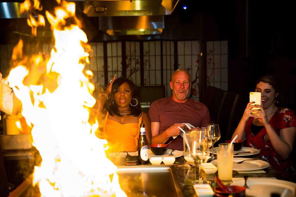 Guests enjoying hibachi dinner around the teppanyaki grill at Asian Bistro
