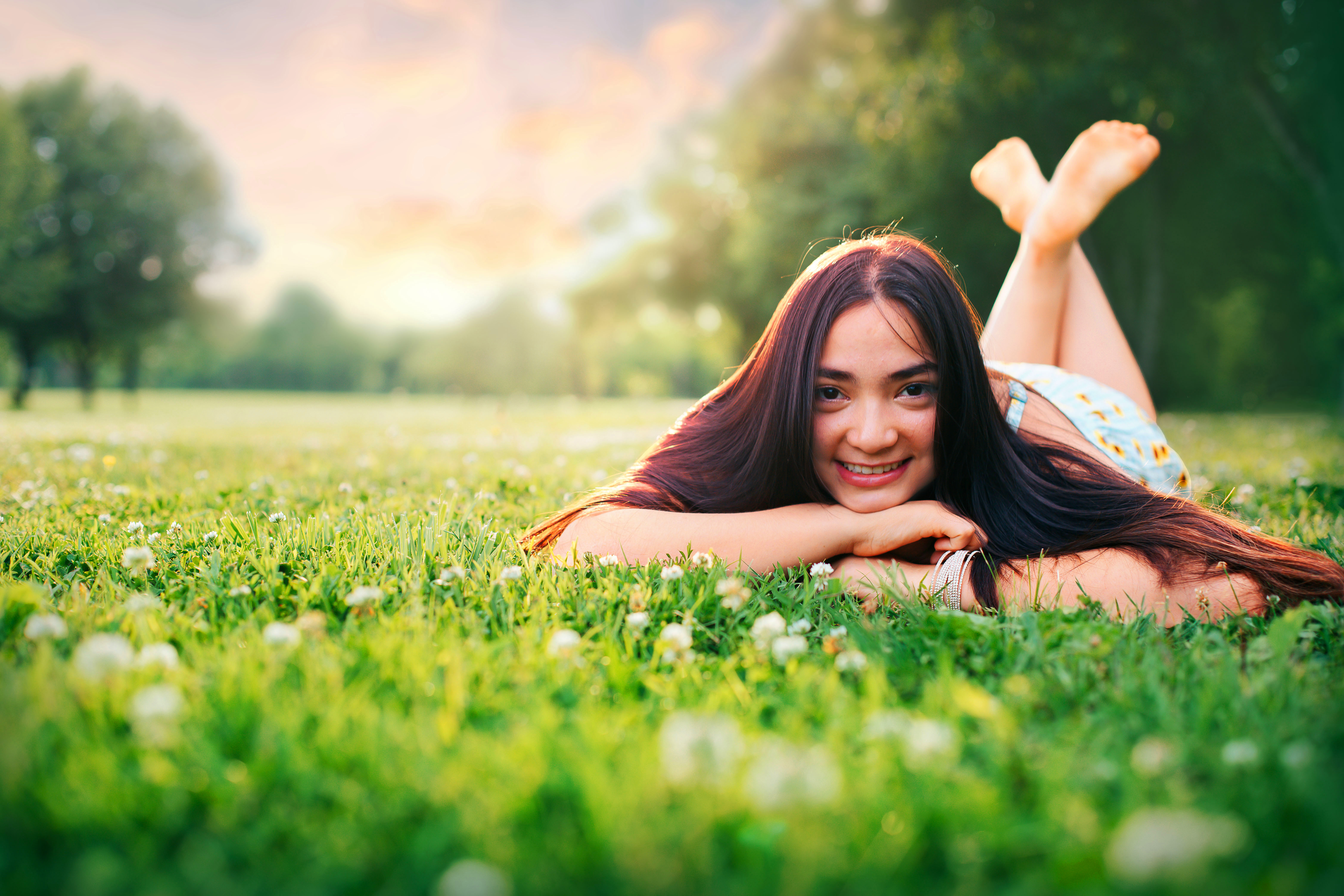 Senior portrait in a sun-drenched wildflower field