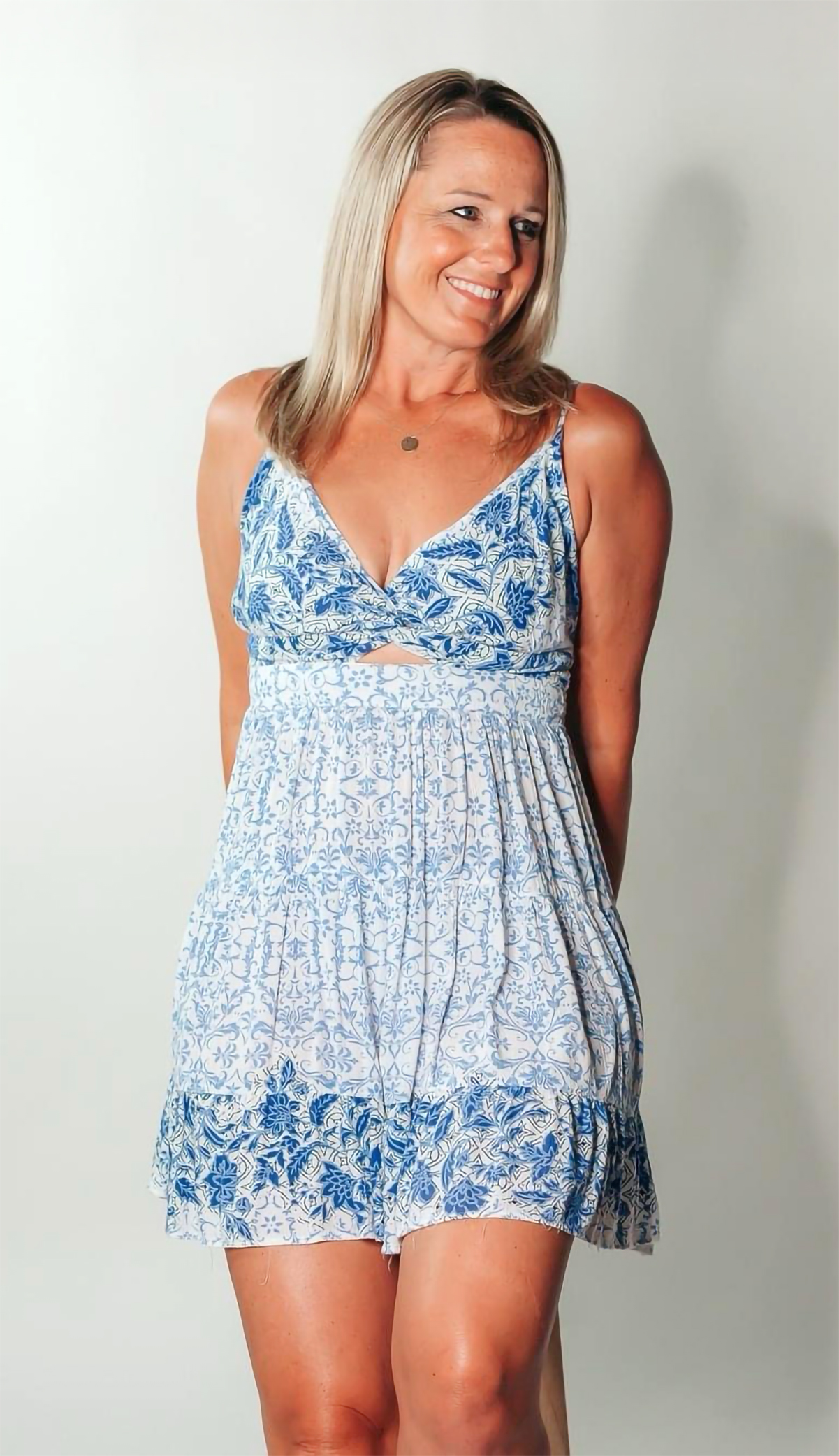 Leianne in a floral dress smiling