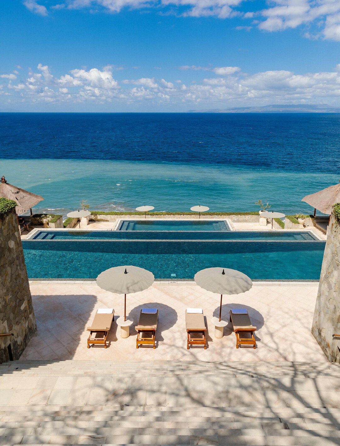 Amankila clifftop three-tiered infinity pool overlooking Lombok Strait Bali