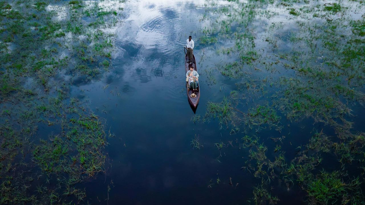Botswana Okavango Delta traditional mokoro canoe safari on lily-covered channels