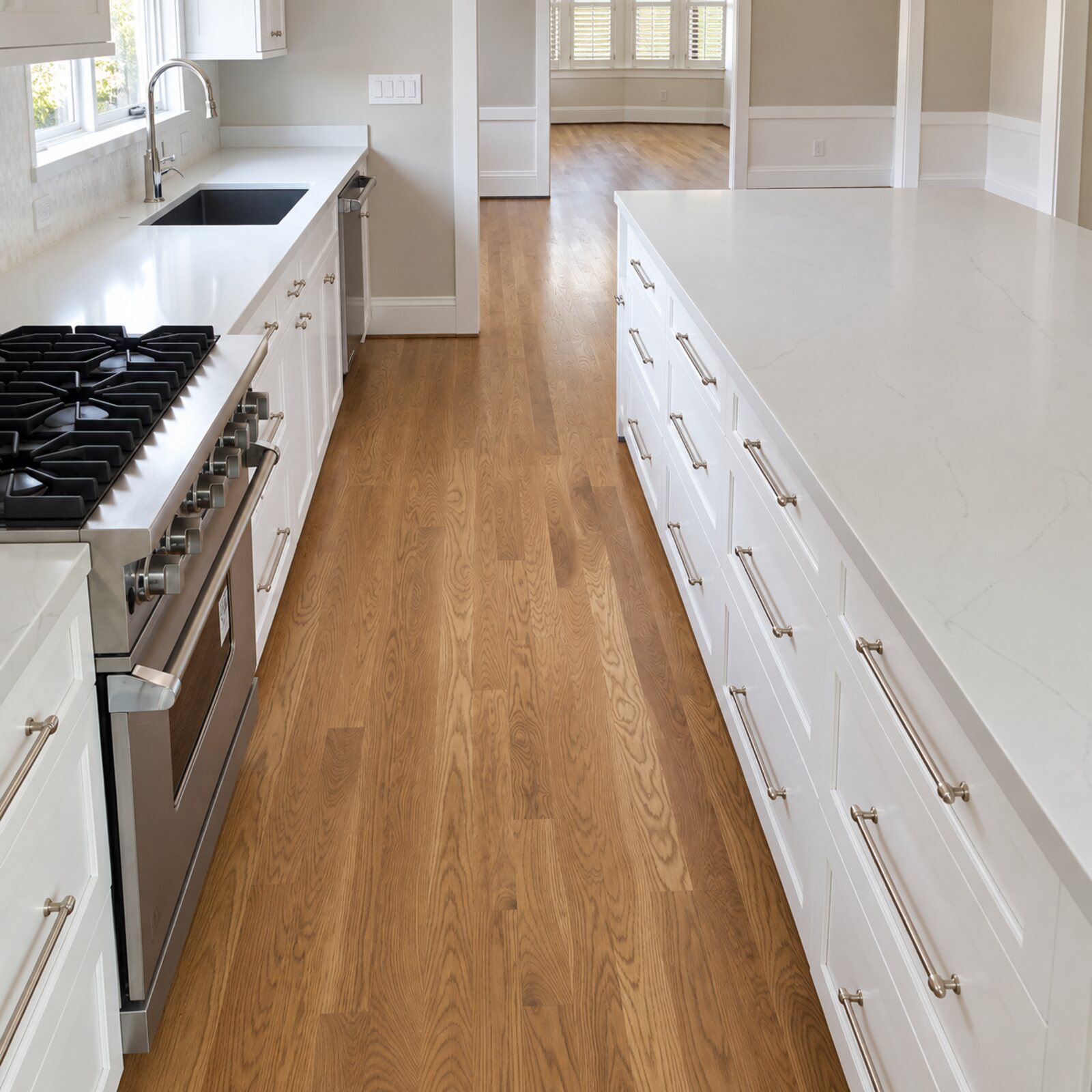 Oak flooring in a white kitchen with a gas range
