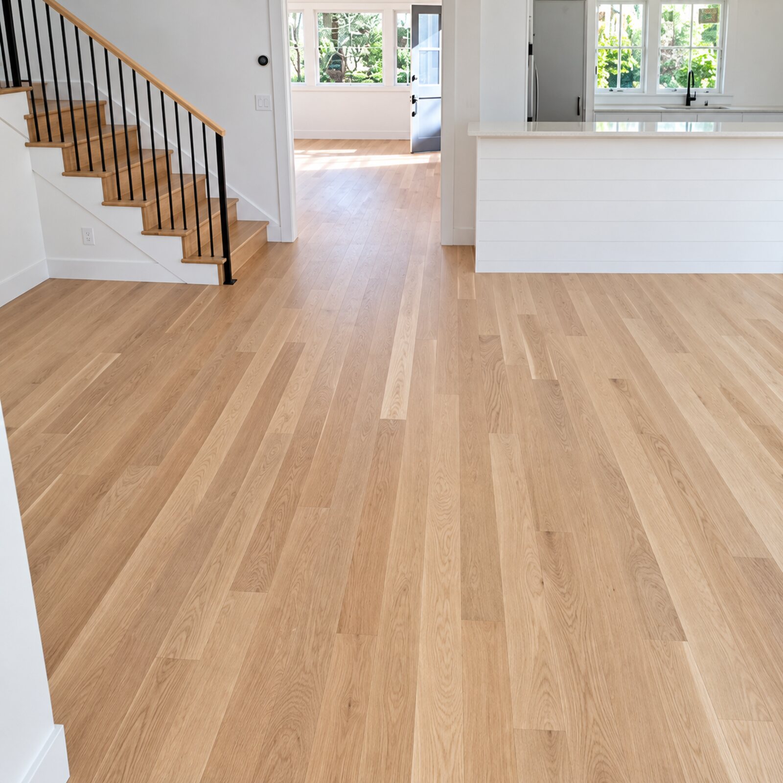 Light oak flooring running through an open-plan living area