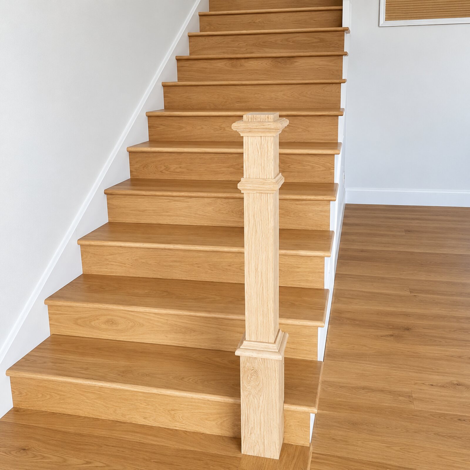 Newly installed natural oak stair treads and risers between white walls