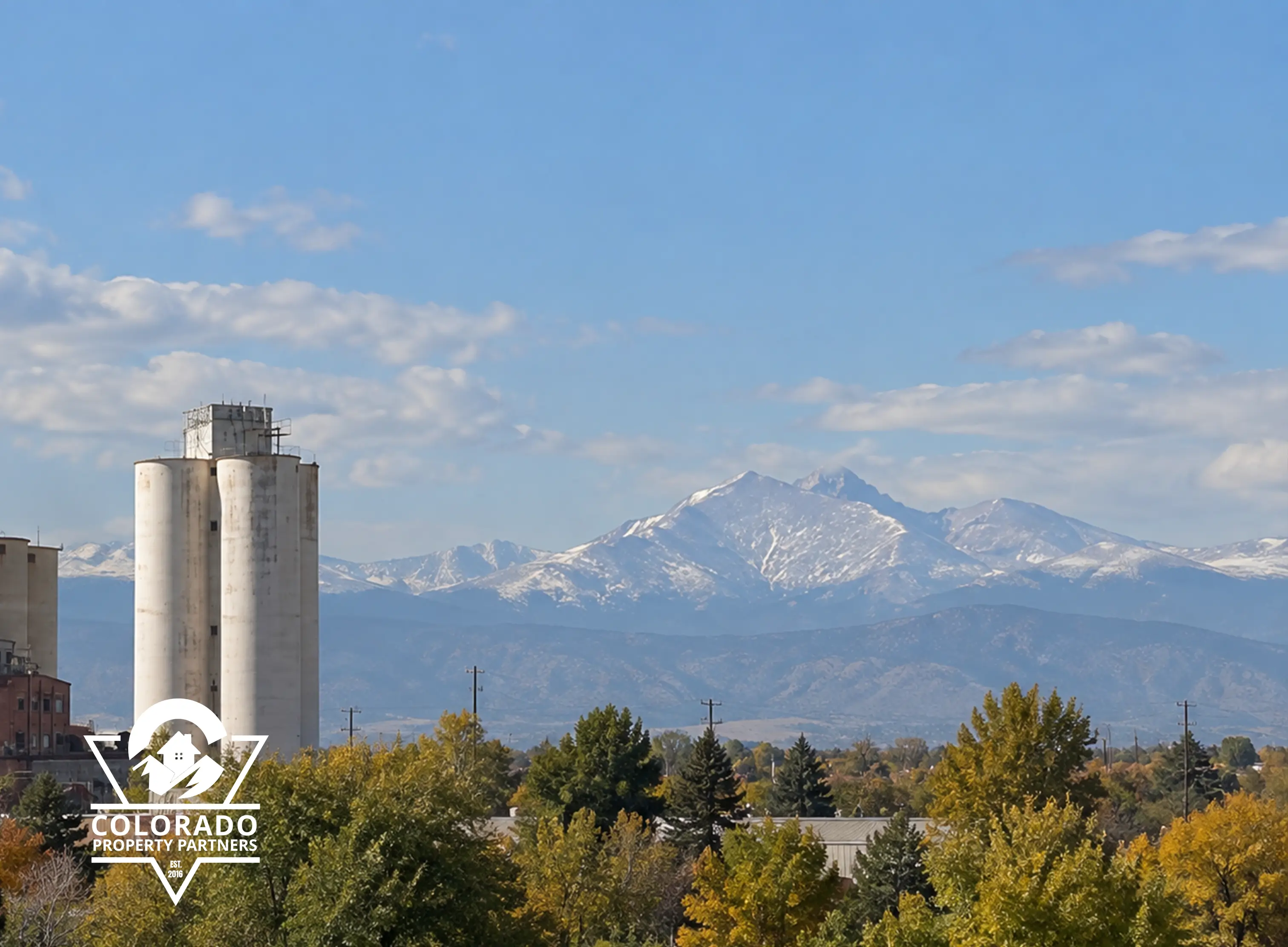 Longmont Colorado historic landmark with Longs Peak mountain view and Colorado Property Partners logo