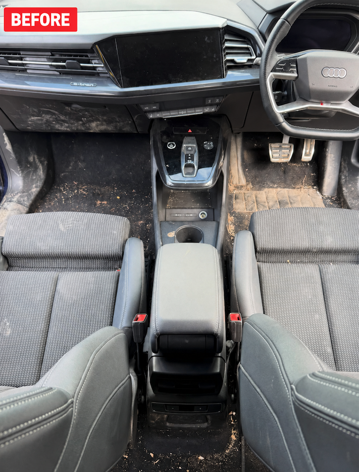 Dusty Audi e-tron front interior cabin with soiled floor before detailing in Savannah