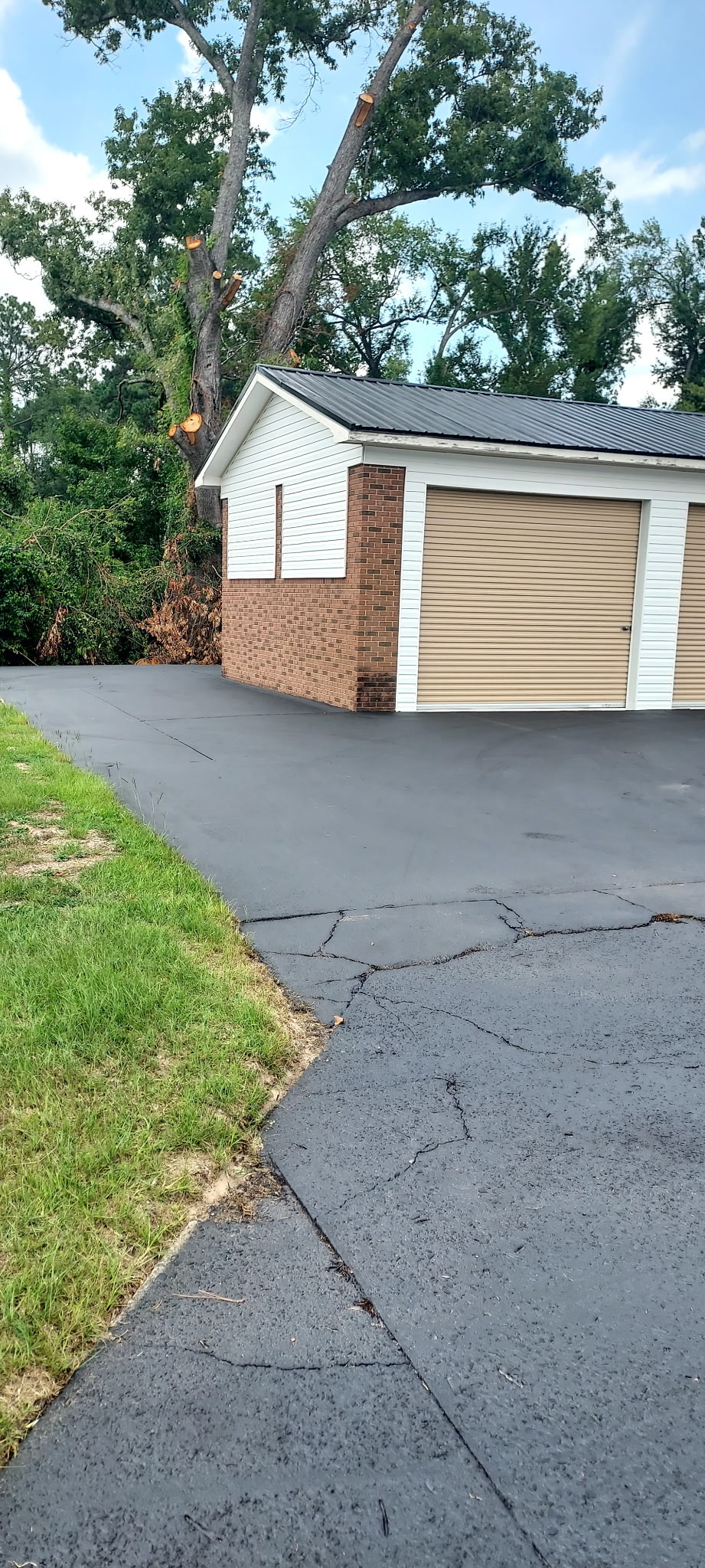 Freshly sealed black driveway after Coastal Plains sealcoating treatment