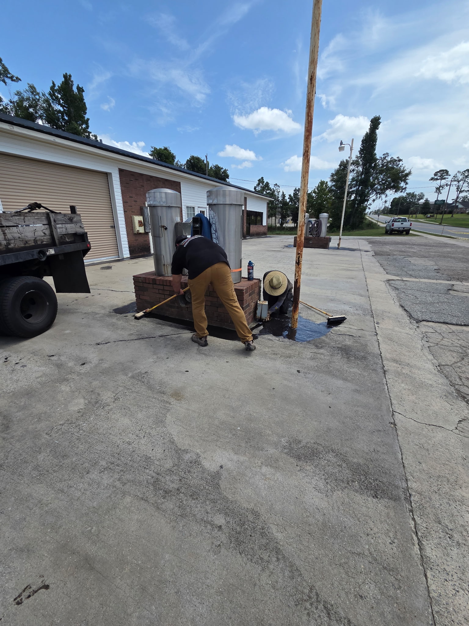 Cracked concrete parking lot before sealcoating by Coastal Plains