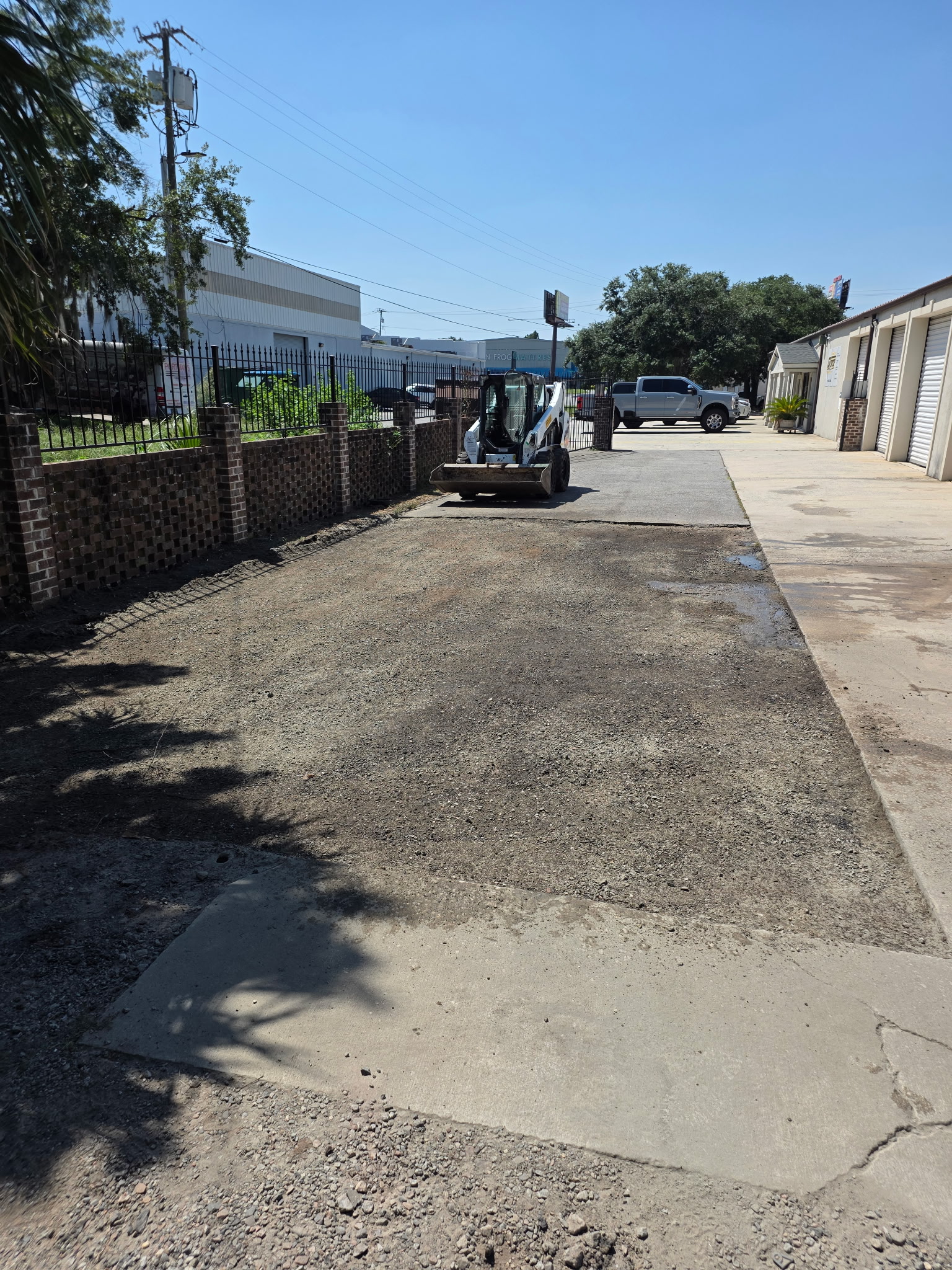 Gravel and dirt driveway before asphalt repair by Coastal Plains