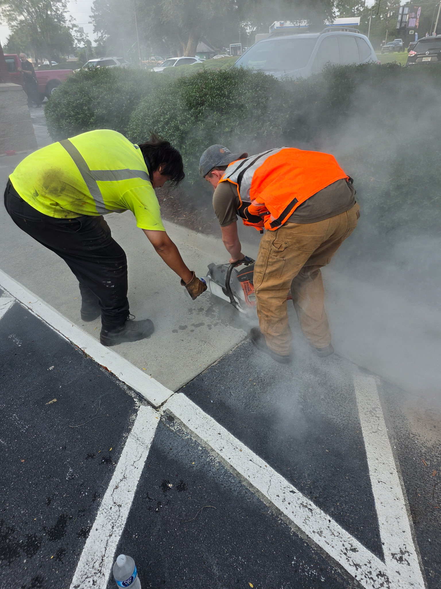 Coastal Plains Sealcoating crew applying fresh asphalt sealcoating on parking lot
