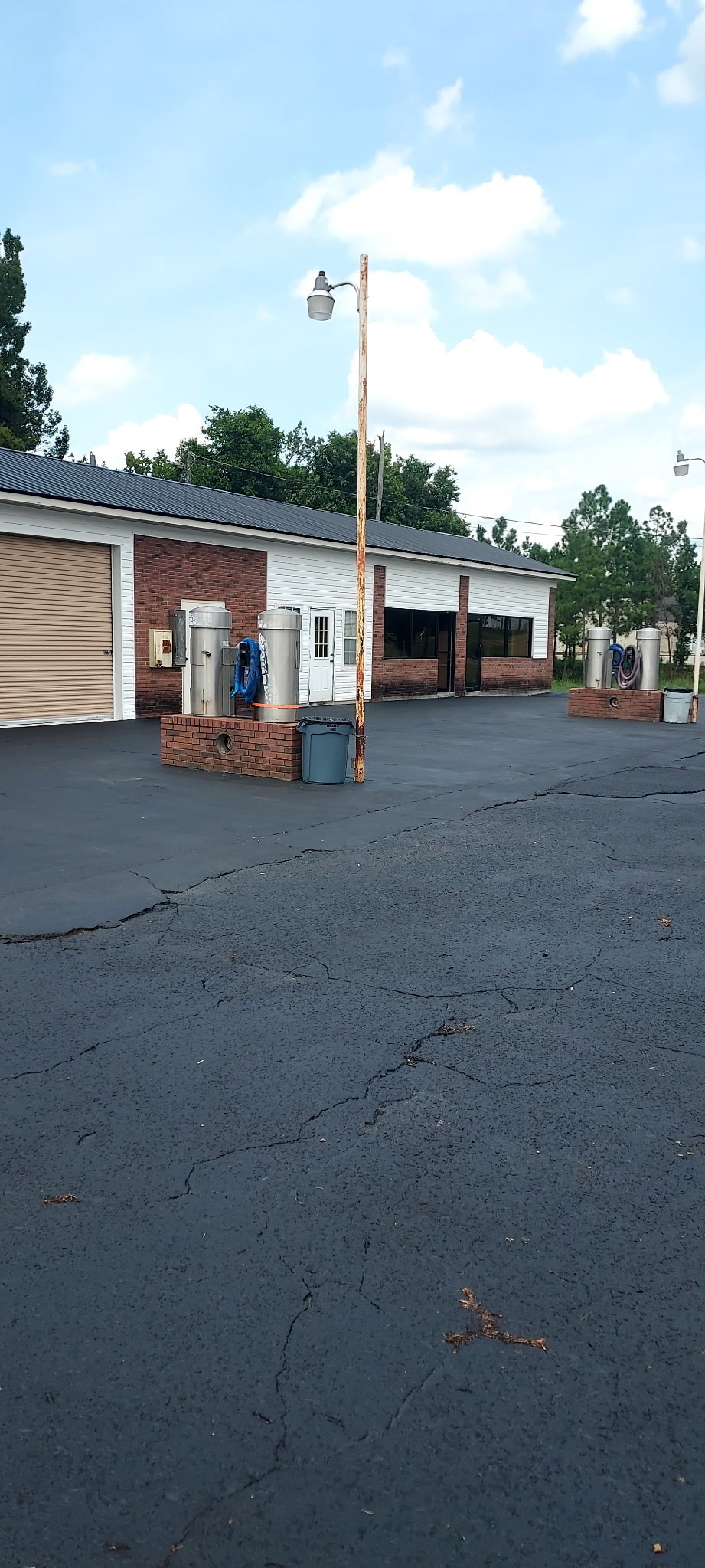Freshly sealed black asphalt lot after treatment by Coastal Plains