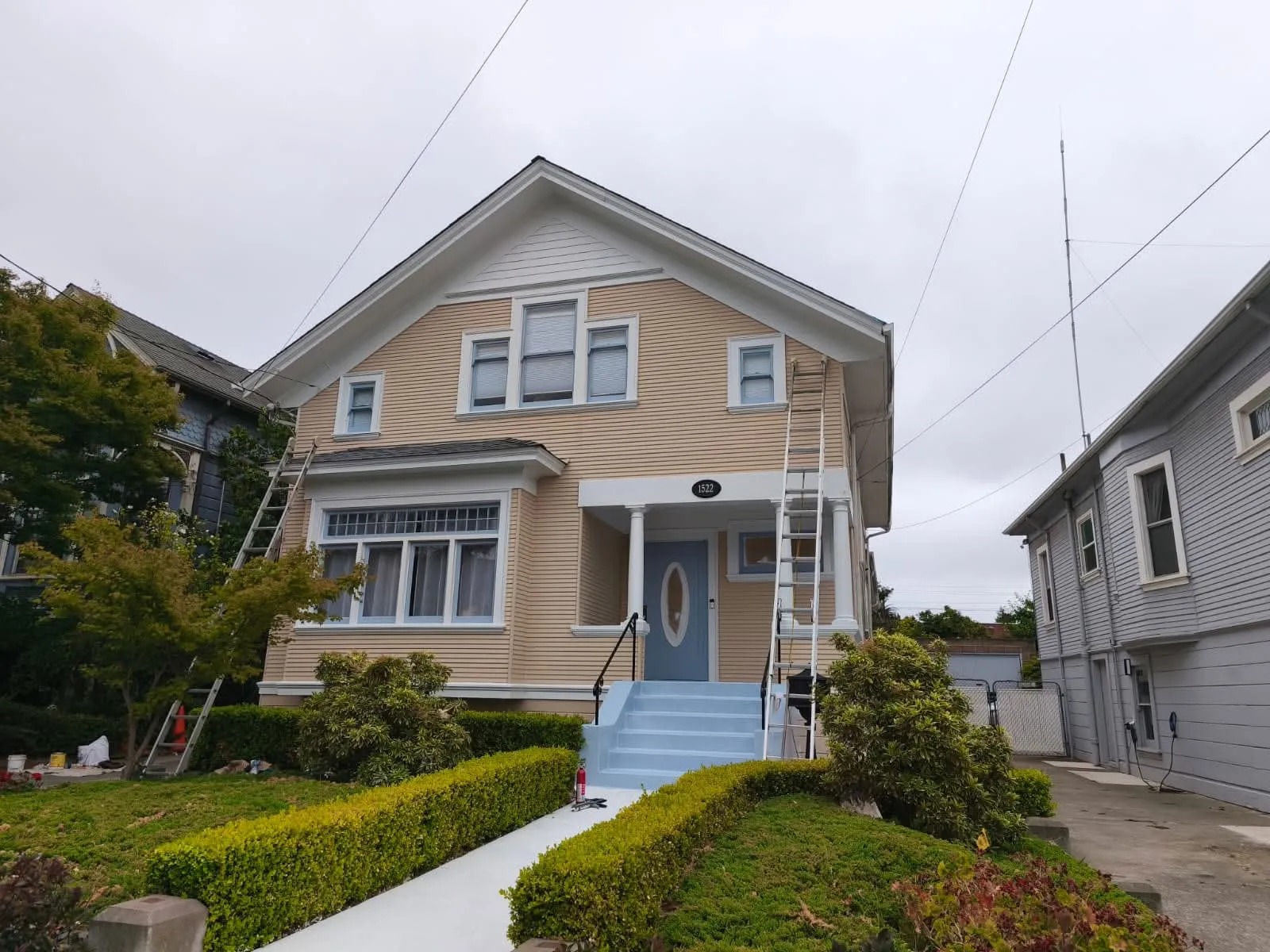 High-reach two-story exterior house painting setup
