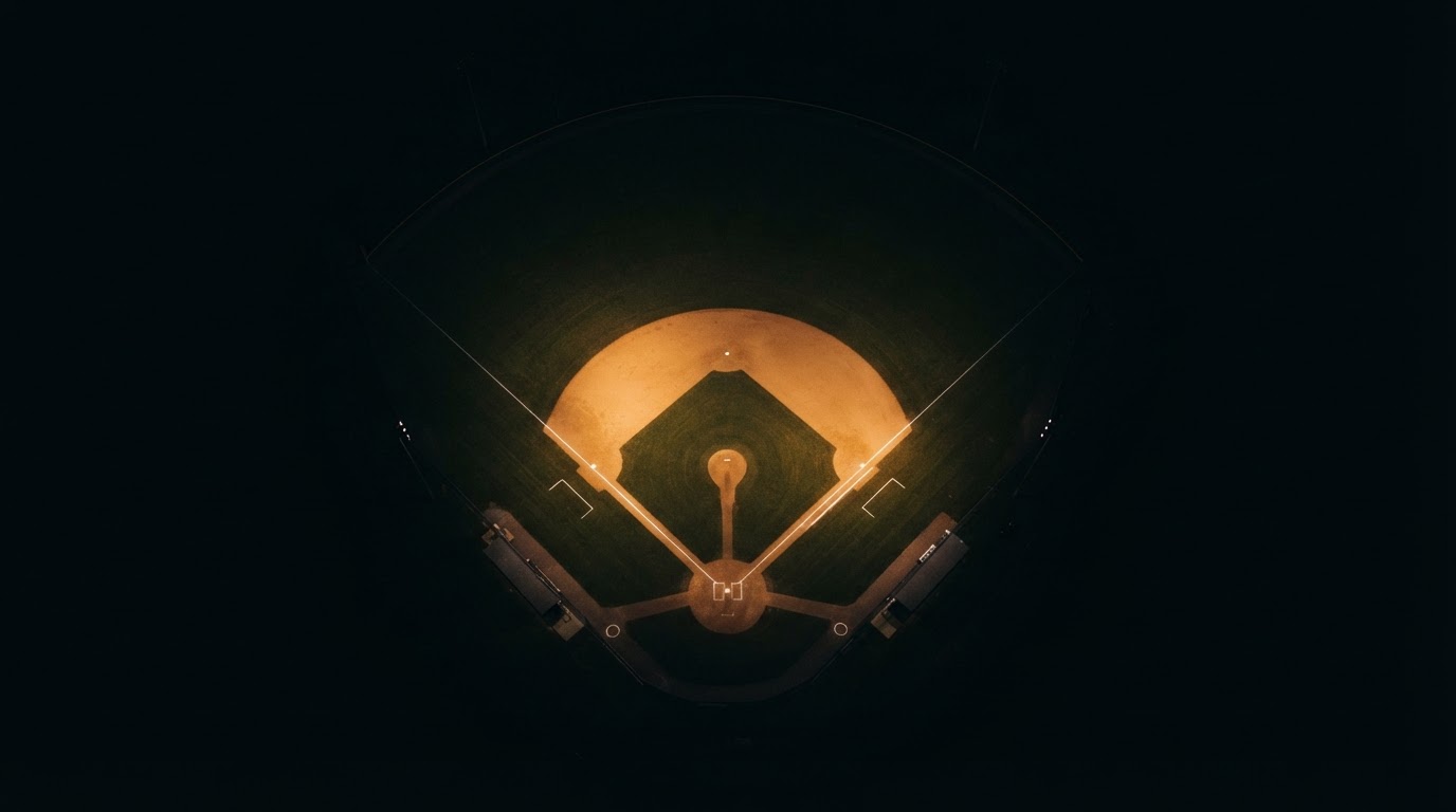 Baseball diamond at night with distant stadium lights fading into darkness