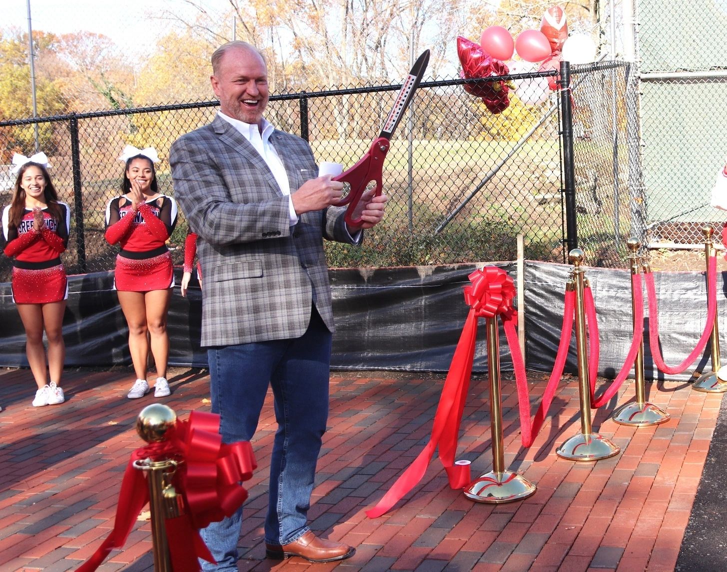 Joe Kelly cutting the ribbon at Cardinal Stadium