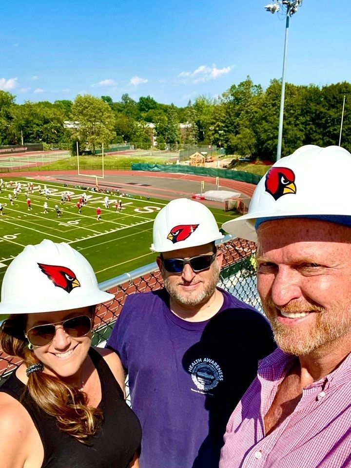 Education - hard hats at Cardinal Stadium football field
