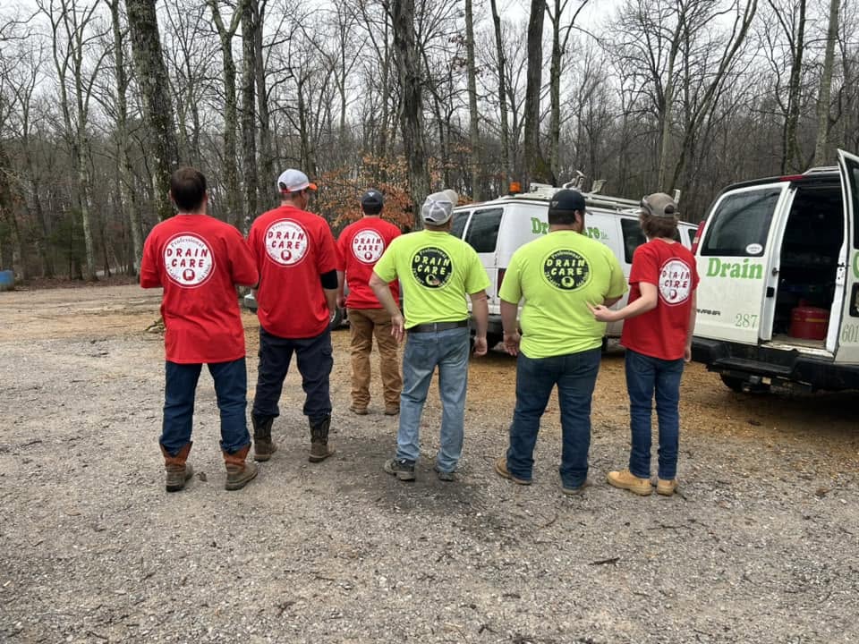 The Drain Care LLC team standing in front of their service vans in Corinth, Mississippi