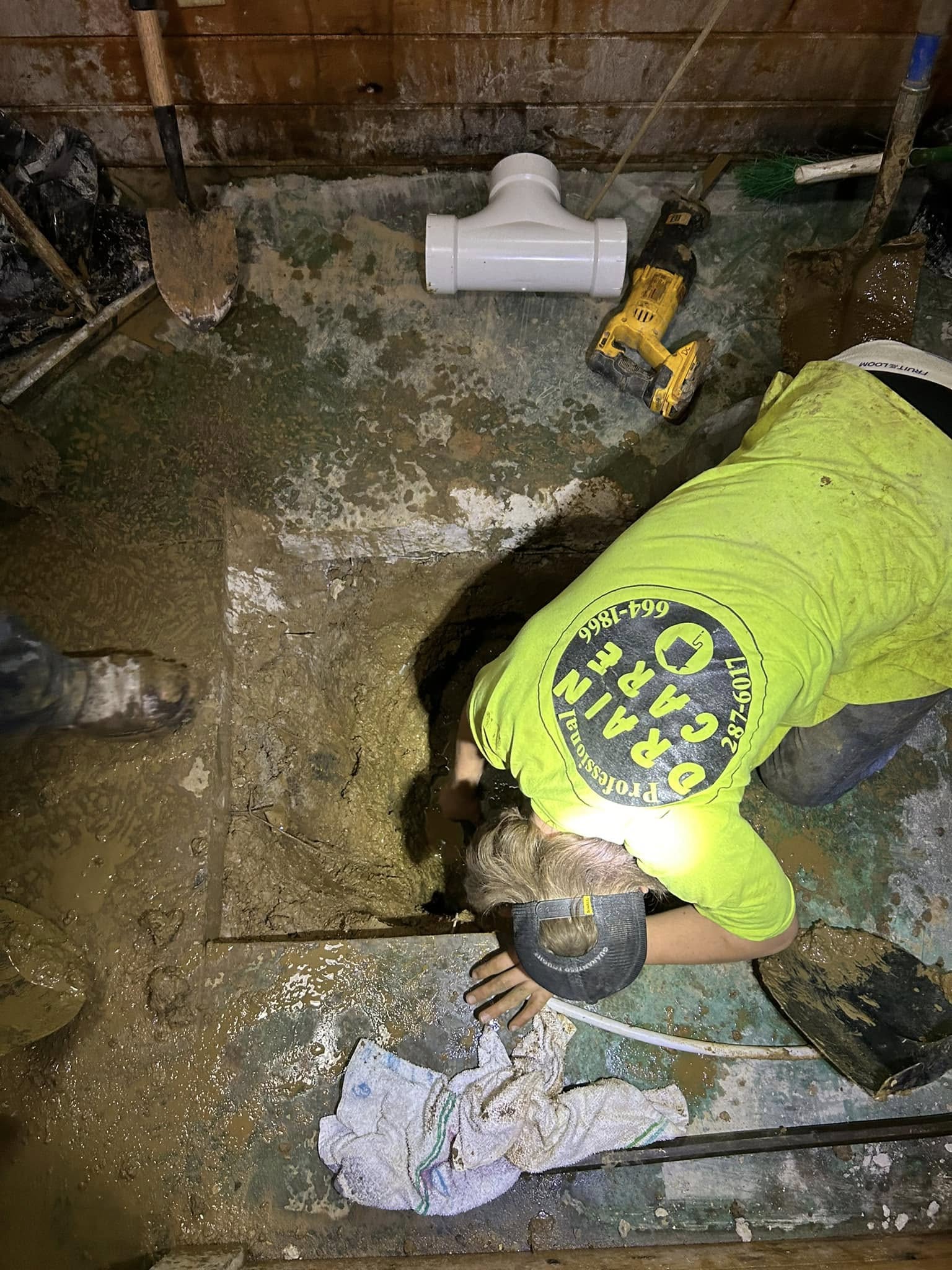 Drain Care LLC technician clearing a crawlspace drain line