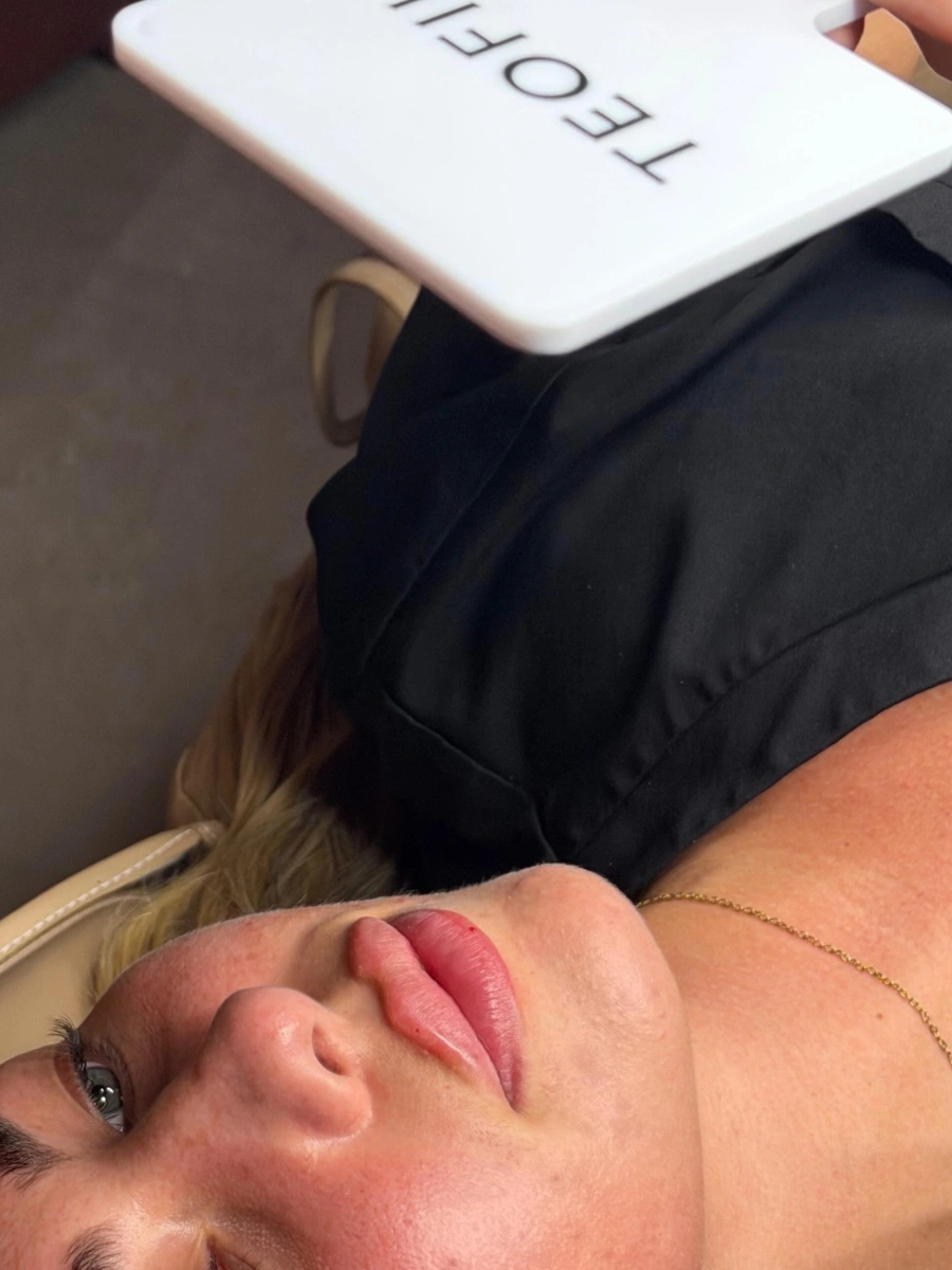 Client admiring fresh lip enhancement contouring result at Burns Salon Luton