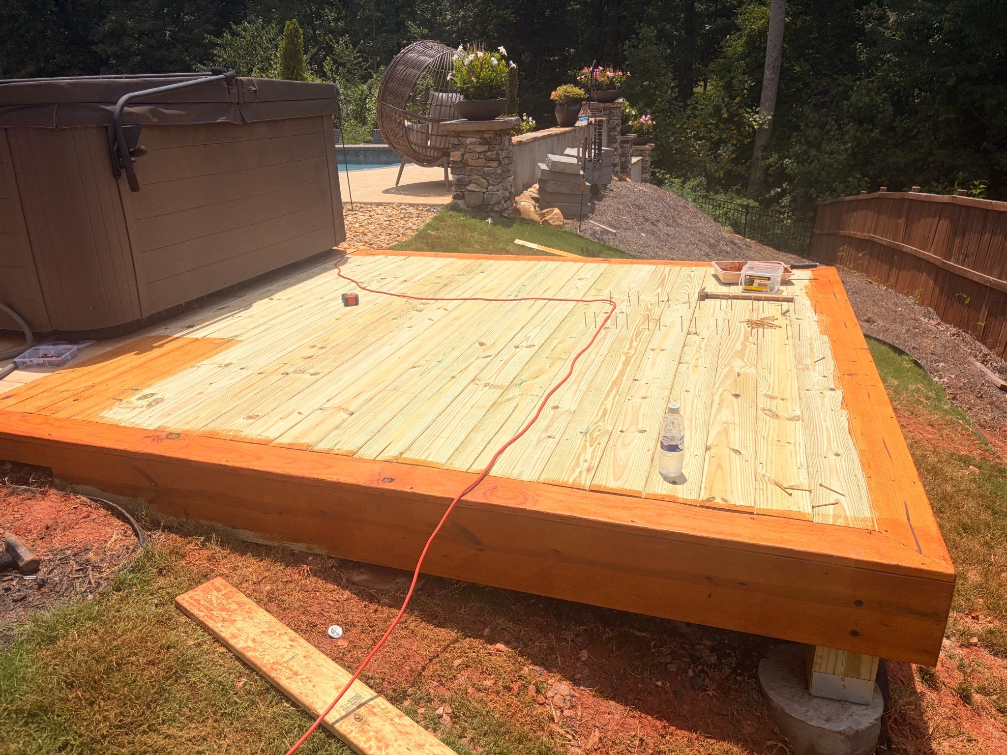 Deck platform flooring completed around hot tub by Limitless Construction Services
