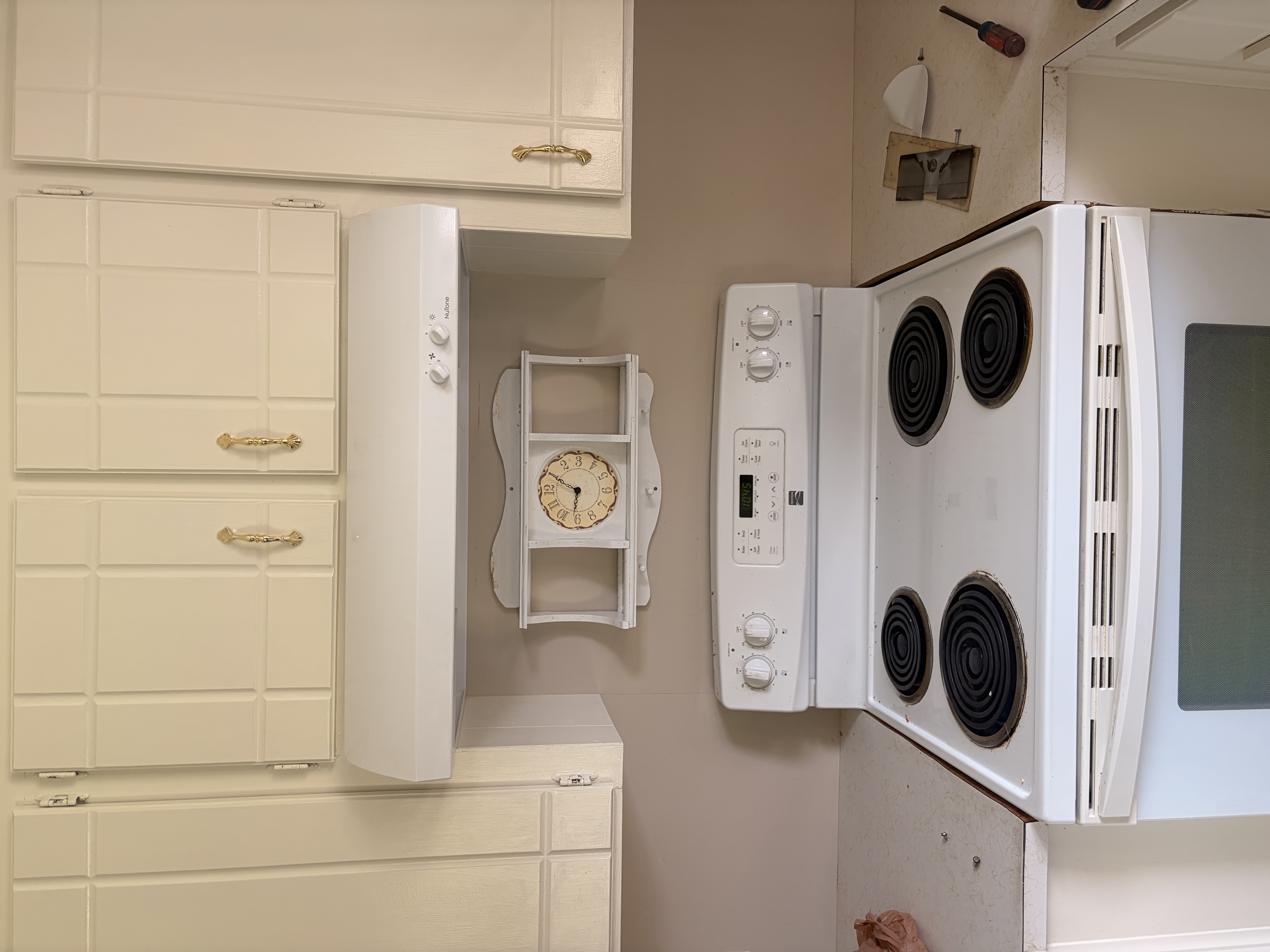 Updated white range hood installed in kitchen by Limitless Construction Services