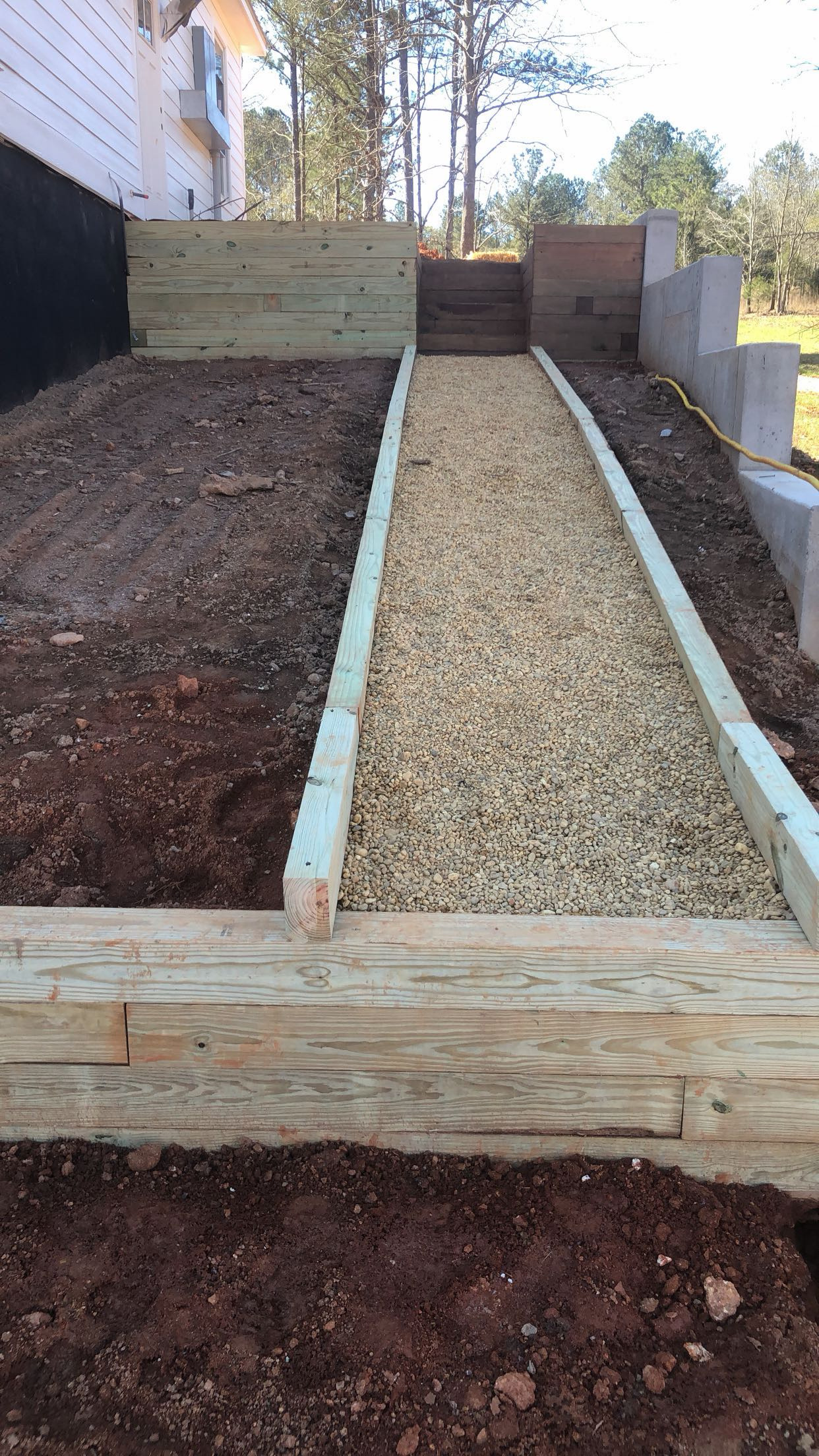 Retaining wall and gravel walkway build by Limitless Construction Services